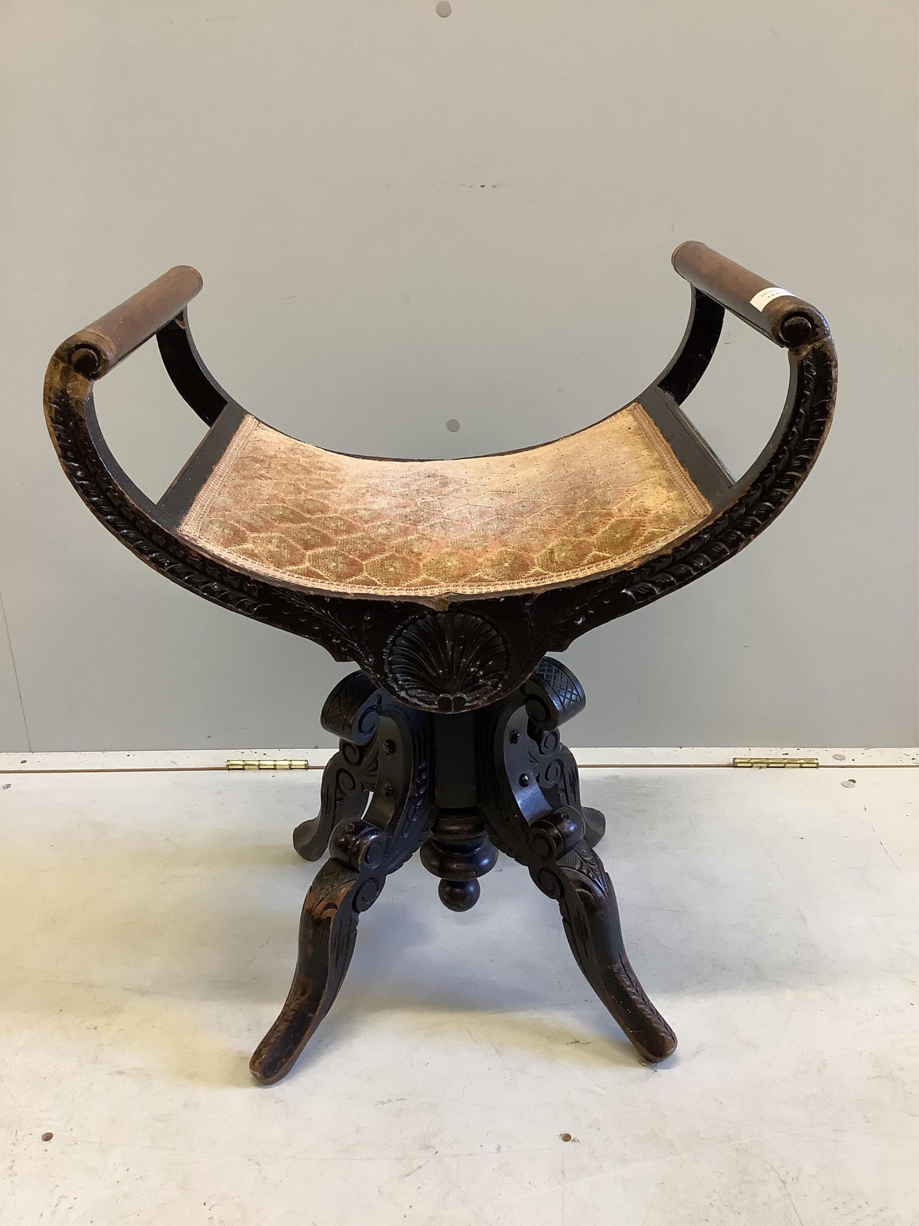 A Victorian carved mahogany adjustable music stool, width 53cm, depth 35cm, height 66cm. Condition - fair